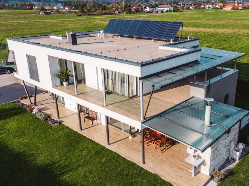 Aerial view of a modern house design in the country side with solar panels on the roof top