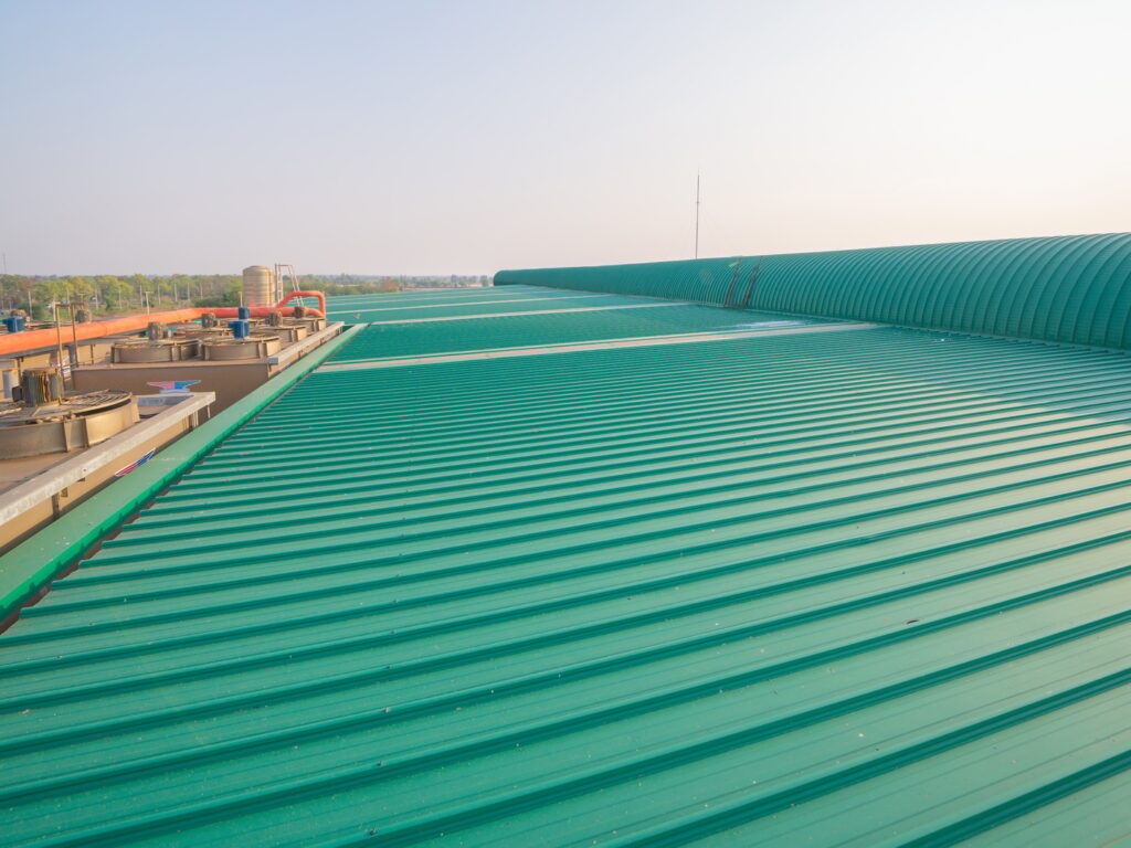 Metal sheet corrugated roof on rooftop of industry factory. Steel structure of station building